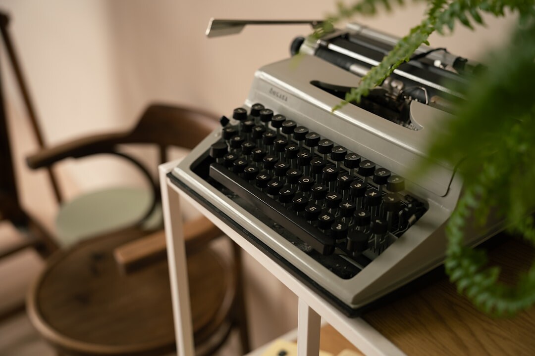 Vintage typewriter on a wooden desk beside a foggy window at night